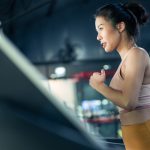 Asian athlete sportswoman practice workout exercise by run on Treadmill to burns calories in gym