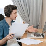 Cheerful man works and studies remotely from home