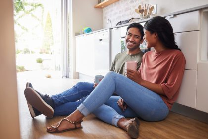 Couple communication, love with coffee in the kitchen and happy together to bond in the morning. Ma