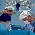 faces of surgeons in the operating room during the operation. Modern medicine, medical workers
