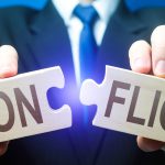 Man breaks puzzles with word Conflict. Resolution of disputes and conflicts in negotiations. Come to