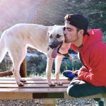 People and their pets in natural light outdoors