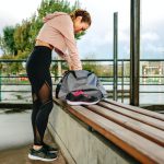 Sportswoman preparing equipment for training