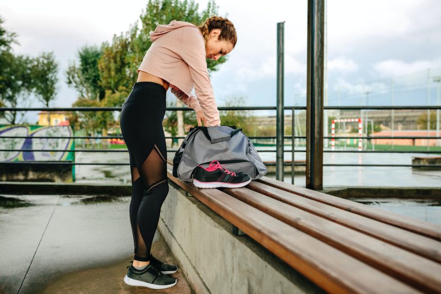 Sportswoman preparing equipment for training