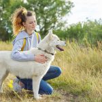 Teenager girl hugging dog, friendship care and love between child and pet