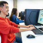 Young multiracial students taking exams in high school - Education and technology concept